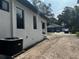 The exterior features large windows, a covered entryway, and a central AC unit at 4241 E Palifox St, Tampa, FL 33610