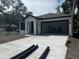 A contemporary home with a spacious two-car garage and newly paved driveway at 4241 E Palifox St, Tampa, FL 33610