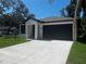 Lovely home with a spacious driveway, attached garage, and neatly kept lawn, all under a clear blue sky at 4241 E Palifox St, Tampa, FL 33610