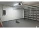 Garage area view shows the gray painted floor, garage door, and storage room at 4241 E Palifox St, Tampa, FL 33610