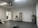 Spacious garage with gray floor, garage door opener, and visible water heater at 4241 E Palifox St, Tampa, FL 33610