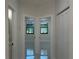 Hallway leading to the bedrooms, featuring contemporary fixtures and marble floors at 4241 E Palifox St, Tampa, FL 33610