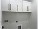 Laundry room highlighting storage cabinets and a sink at 4241 E Palifox St, Tampa, FL 33610