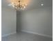 Expansive living room with modern lighting, sleek floors, and a spacious layout for versatile arrangements at 4241 E Palifox St, Tampa, FL 33610