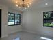 Bright and open living area with sleek floors, modern lighting, and large windows offering ample natural light at 4241 E Palifox St, Tampa, FL 33610