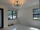 Spacious living area featuring modern lighting, large windows, and elegant flooring at 4241 E Palifox St, Tampa, FL 33610