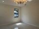 Bright living room features a modern light fixture, recessed lights, and elegant floors at 4241 E Palifox St, Tampa, FL 33610