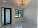 Bright, airy living room with large windows, sleek tile floors, and a modern light fixture at 4241 E Palifox St, Tampa, FL 33610
