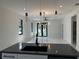 Open-concept space showcasing modern pendants, a fan, and stylish light fixture at 4241 E Palifox St, Tampa, FL 33610