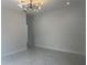 Open living space boasts stylish light fixtures, neutral walls, and elegant flooring at 4241 E Palifox St, Tampa, FL 33610