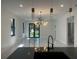 Open living area featuring modern lighting, sleek floors, and large windows that provide plenty of natural light at 4241 E Palifox St, Tampa, FL 33610