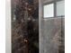 Close-up of shower with modern fixtures and beautiful decorative tiling, offering a spa-like experience at 4241 E Palifox St, Tampa, FL 33610