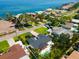 Aerial view showcasing the home's prime waterfront location with lush landscaping and a backyard pool at 4618 Bayshore Ne Blvd, St Petersburg, FL 33703