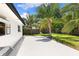 Spacious backyard featuring a large patio area and lush landscaping with mature palm trees at 4618 Bayshore Ne Blvd, St Petersburg, FL 33703