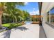 Expansive backyard oasis with a sparkling pool, covered patio, lush lawn, and tropical landscaping at 4618 Bayshore Ne Blvd, St Petersburg, FL 33703