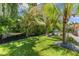 Private backyard with tropical landscaping, a hammock, and seating, perfect for relaxing at 4618 Bayshore Ne Blvd, St Petersburg, FL 33703