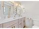 Bright bathroom features double vanity with gold hardware and contemporary mirrors at 4618 Bayshore Ne Blvd, St Petersburg, FL 33703