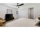 Bright bedroom with hardwood floors, flatscreen TV, and ceiling fan at 4618 Bayshore Ne Blvd, St Petersburg, FL 33703