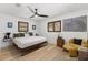 Bright bedroom with white walls, wood floors, and shuttered windows at 4618 Bayshore Ne Blvd, St Petersburg, FL 33703