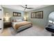 Cozy bedroom offers light green walls, two windows and neutral decor at 4618 Bayshore Ne Blvd, St Petersburg, FL 33703