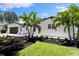 Landscaped front yard with palm trees in front of a painted brick home at 4618 Bayshore Ne Blvd, St Petersburg, FL 33703