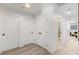 Hallway with hardwood floors and white doors leading to different rooms at 4618 Bayshore Ne Blvd, St Petersburg, FL 33703