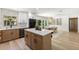Open kitchen with modern stainless appliances, wooden cabinets, and view into dining area at 4618 Bayshore Ne Blvd, St Petersburg, FL 33703