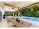 Inviting patio with a covered dining area, pool views, and comfortable seating arrangements at 4618 Bayshore Ne Blvd, St Petersburg, FL 33703