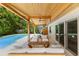 Stylish patio with a covered ceiling and comfortable seating arrangement overlooking the pool at 4618 Bayshore Ne Blvd, St Petersburg, FL 33703