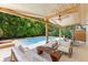 Elegant patio with plush outdoor seating, pool views, and a covered ceiling with a ceiling fan at 4618 Bayshore Ne Blvd, St Petersburg, FL 33703
