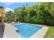Inviting pool area with tiled deck, lounge chairs, and lush landscaping, perfect for relaxation and outdoor enjoyment at 4618 Bayshore Ne Blvd, St Petersburg, FL 33703