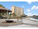 Condo complex featuring outdoor recreational area, fire pit, picnic area, kayak storage, and waterfront access at 4900 Brittany S Dr # 209, St Petersburg, FL 33715