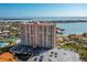 High-rise condominium building with waterfront views, landscaping, and a large parking lot at 4900 Brittany S Dr # 209, St Petersburg, FL 33715