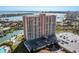 Exterior shot of the waterfront condo featuring a parking lot, well-manicured landscaping, and canal access at 4900 Brittany S Dr # 209, St Petersburg, FL 33715