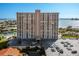 Exterior shot of a waterfront condo featuring parking, well-manicured landscaping, and canal access at 4900 Brittany S Dr # 209, St Petersburg, FL 33715