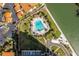 Aerial view of a community pool with seating, landscaping and parking near the waterfront at 4900 Brittany S Dr # 209, St Petersburg, FL 33715