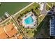 Aerial view of the community pool surrounded by lounge chairs, umbrellas and lush landscaping at 4900 Brittany S Dr # 209, St Petersburg, FL 33715