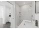 Modern bathroom featuring white marble walls and a frameless shower at 5013 W Mccoy St, Tampa, FL 33616