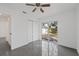 Bedroom featuring gray tiled floors, neutral paint, a closet, and a sliding glass door leading to the backyard at 5013 W Mccoy St, Tampa, FL 33616
