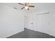 This is a bedroom with a ceiling fan and gray tile floor and a closet at 5013 W Mccoy St, Tampa, FL 33616