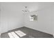 Cozy bedroom with gray tile floors, recessed lighting, and a modern chandelier at 5013 W Mccoy St, Tampa, FL 33616