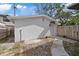 Backyard view of the home featuring white paint and a walkway at 5013 W Mccoy St, Tampa, FL 33616