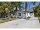 Single-story home with a freshly painted white exterior and a concrete driveway at 5013 W Mccoy St, Tampa, FL 33616