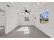 Bright living room with gray floors, modern ceiling fan, and natural light at 5013 W Mccoy St, Tampa, FL 33616