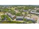 A captivating aerial view of townhomes near a lush golf course and water, offering a serene community atmosphere at 5435 Sweetwater Terrace Cir, Tampa, FL 33634