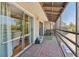 Spacious screened balcony featuring wood floors and exterior access at 5435 Sweetwater Terrace Cir, Tampa, FL 33634