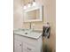 Bathroom featuring a clear glass vessel sink, white cabinetry, and modern lighting at 5435 Sweetwater Terrace Cir, Tampa, FL 33634
