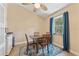 Cozy dining area features a ceiling fan, square table, and a window with blue curtains at 5435 Sweetwater Terrace Cir, Tampa, FL 33634