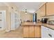 Functional kitchen with island counter, pantry, and tile flooring at 5435 Sweetwater Terrace Cir, Tampa, FL 33634