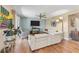 Cozy living room with hardwood floors, a ceiling fan, and plenty of natural light at 5435 Sweetwater Terrace Cir, Tampa, FL 33634